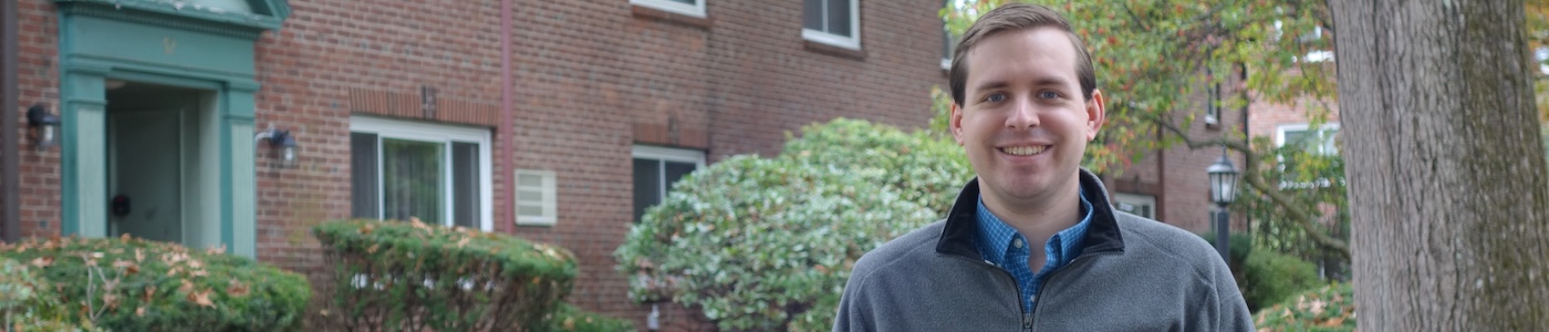 Hero Banner of Bill Humphrey standing in front of a residential building, wearing a fleece.